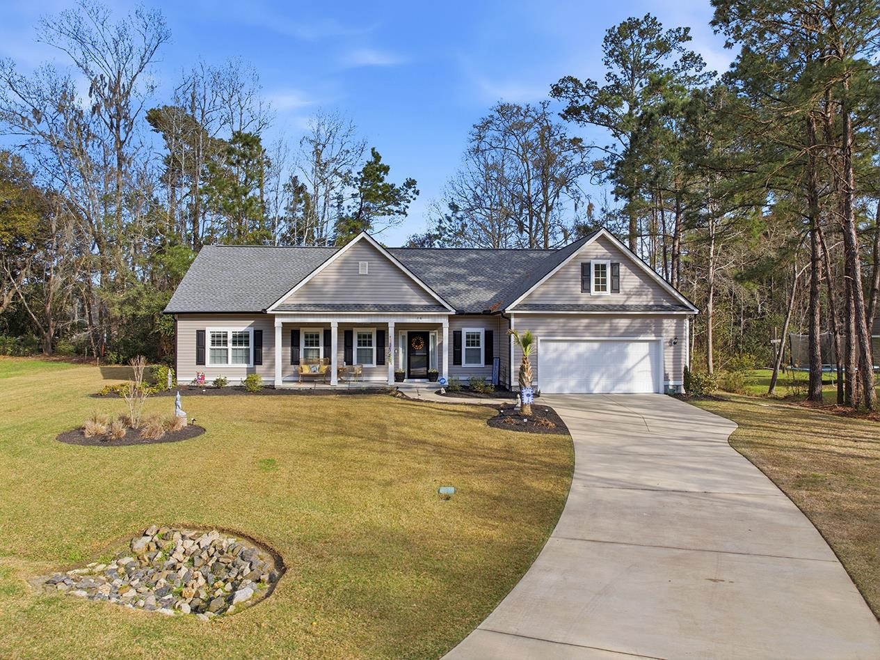 76 Governor Boone Lane Georgetown, SC 29440 - Photo 1 of 83 View of the Front of this spectacular home in Wedgefield Plantation, showing the beautifully landscaped front lawn and welcoming front porch.