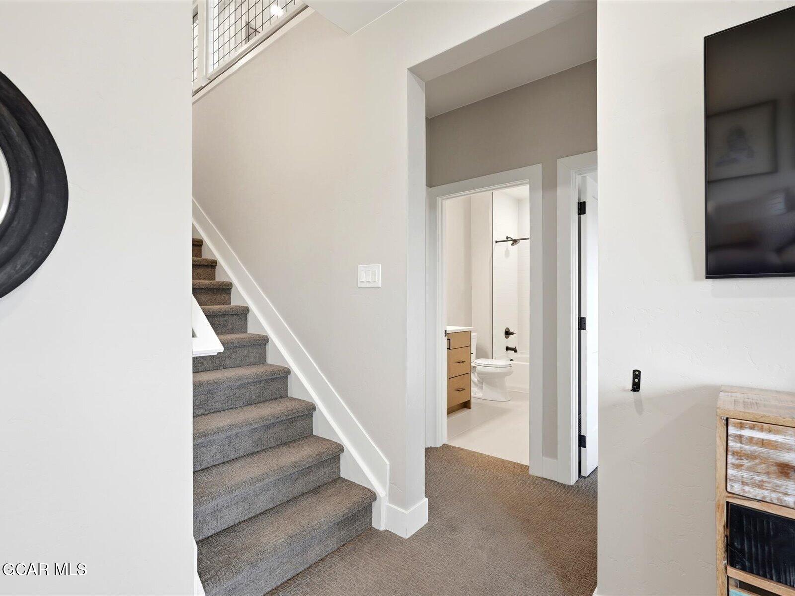 95 River Run Circle Fraser, CO 80442 - Photo 51 of 66 a view of a hallway with wooden floor and staircase