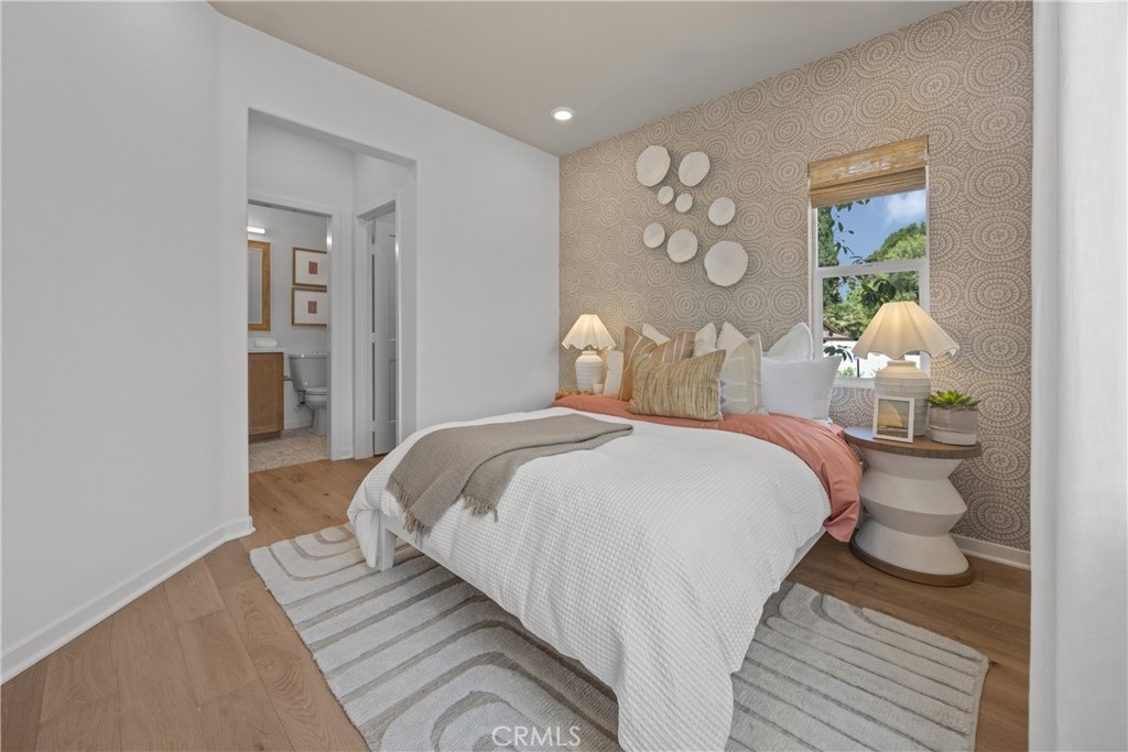 7373 Suva Street Downey, CA 90240 - Photo 13 of 14 a bedroom with a bed and wooden floor