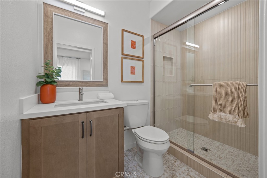 7373 Suva Street Downey, CA 90240 - Photo 14 of 14 a bathroom with a sink a toilet and shower