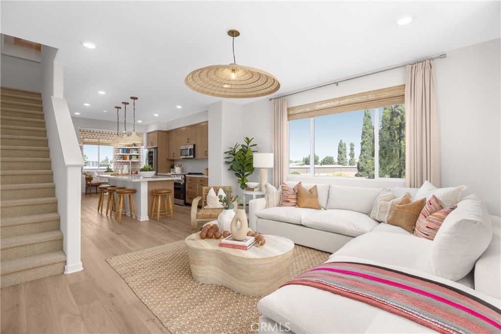 7373 Suva Street Downey, CA 90240 - Photo 3 of 14 a living room with furniture and a large window