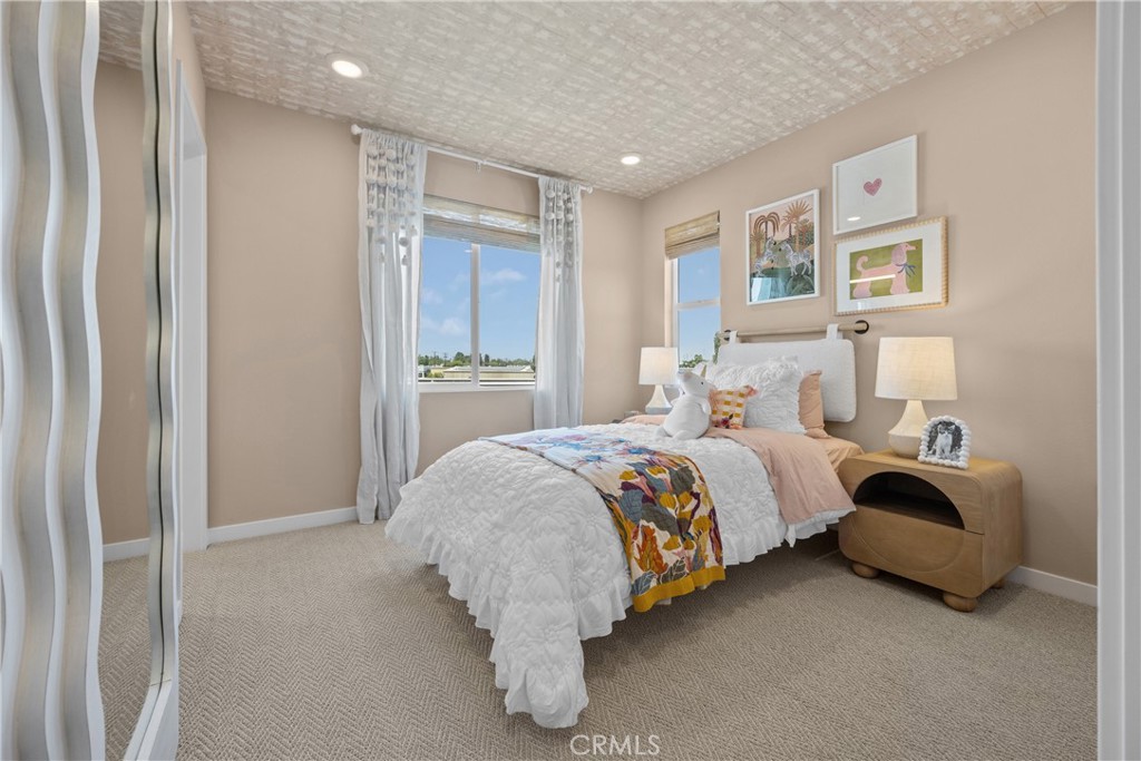 7373 Suva Street Downey, CA 90240 - Photo 9 of 14 a spacious bedroom with a bed and a painting