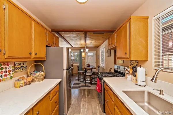 a kitchen that has a sink and a stove top oven