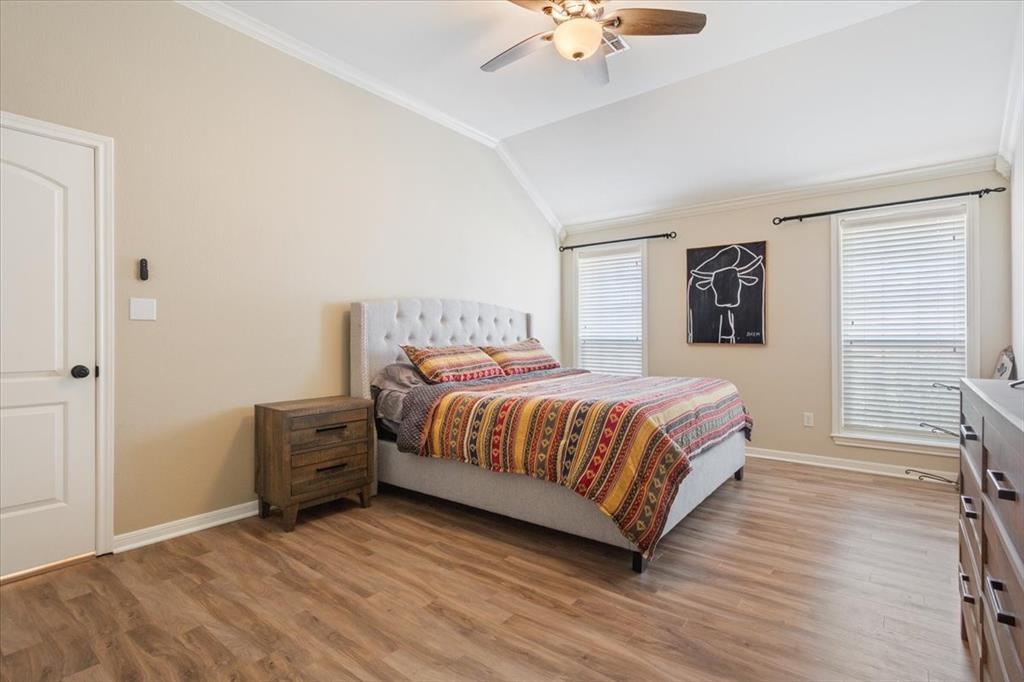 203 Silver Spur Trail Waco, TX 76657 - Photo 15 of 39 Bedroom featuring ornamental molding, light wood-style flooring, vaulted ceiling, and ceiling fan