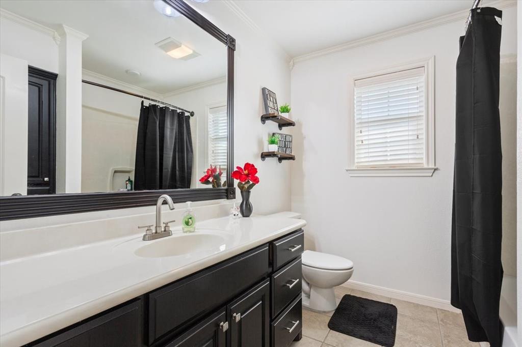 203 Silver Spur Trail Waco, TX 76657 - Photo 25 of 39 Bathroom with vanity, tile patterned flooring, plenty of natural light, and ornamental molding