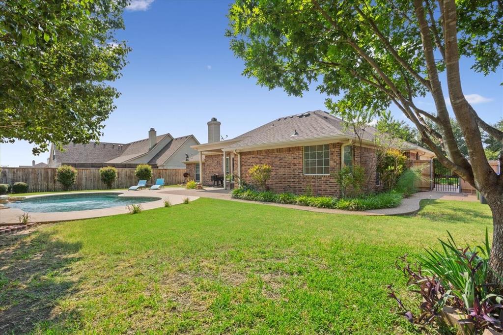 203 Silver Spur Trail Waco, TX 76657 - Photo 34 of 39 Back of house featuring a fenced backyard, a patio, brick siding, and a chimney