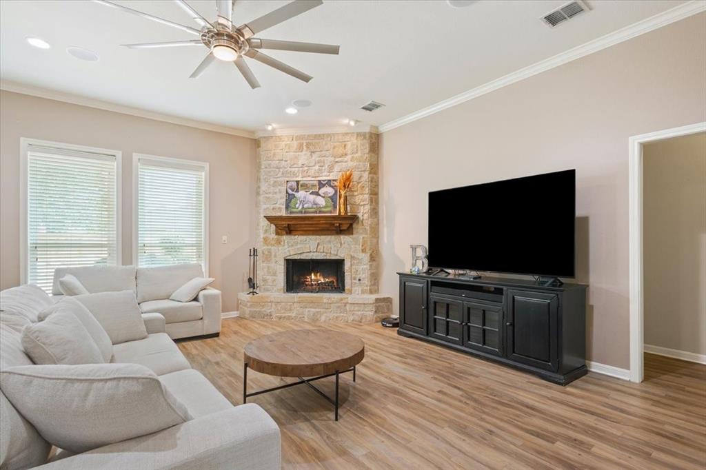 203 Silver Spur Trail Waco, TX 76657 - Photo 7 of 39 Living area featuring ornamental molding, light wood finished floors, a ceiling fan, a fireplace, and recessed lighting