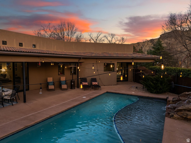 98 Bridge Road Rockville, UT 84763 - Photo 47 of 75 Pool at dusk with a patio area