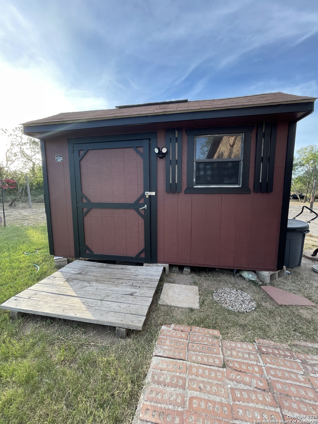 311 3rd Street Christine, TX 78012 - Photo 3 of 10 a front view of a house with garden