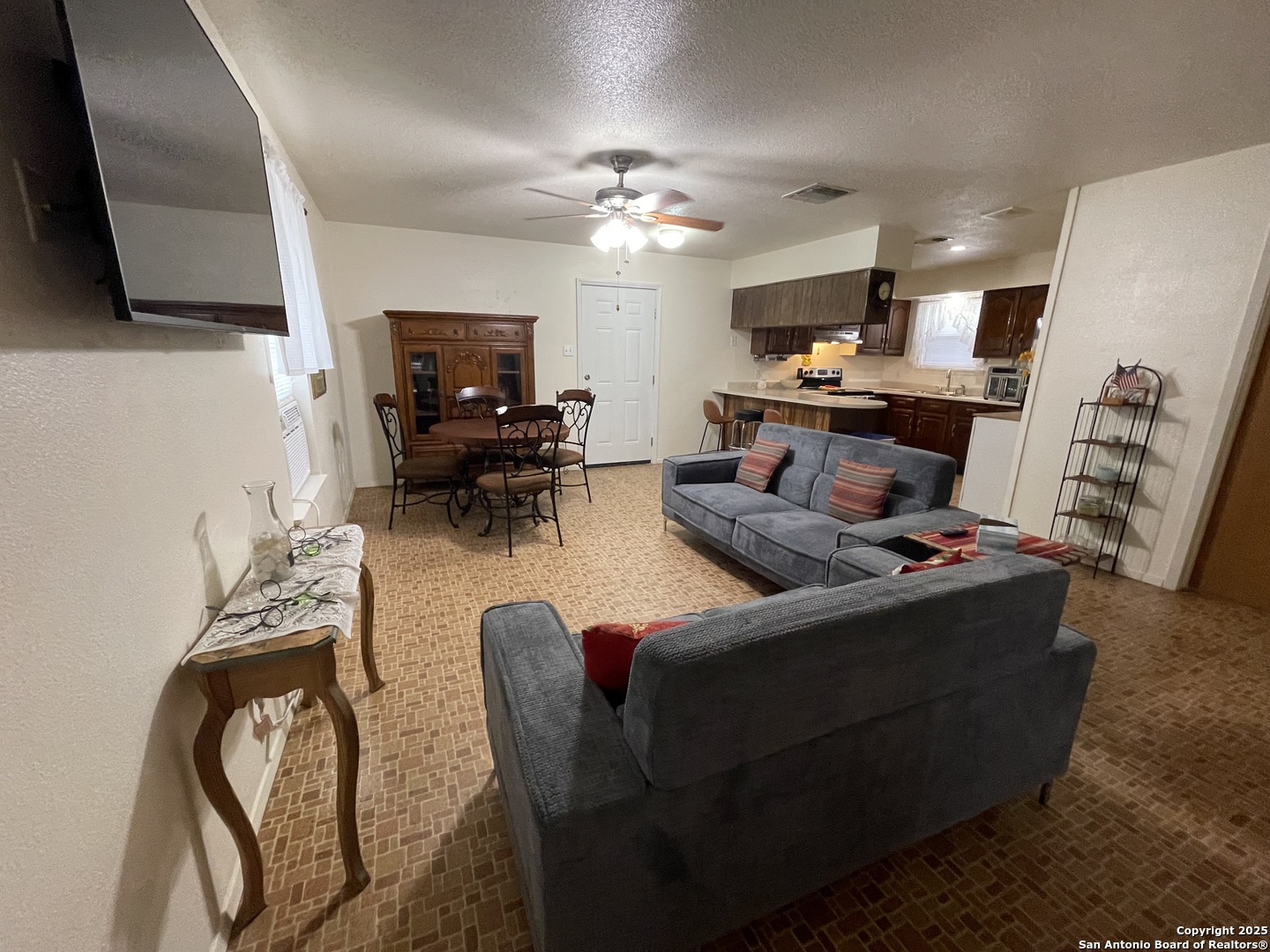 311 3rd Street Christine, TX 78012 - Photo 4 of 10 a living room with furniture and a flat screen tv