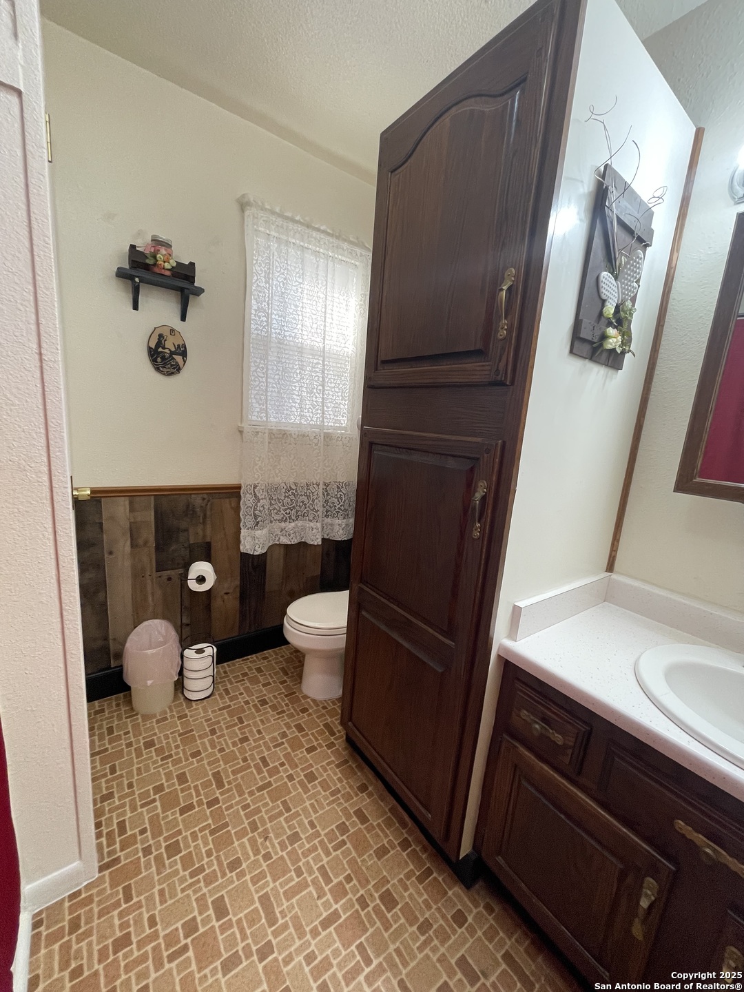 311 3rd Street Christine, TX 78012 - Photo 5 of 10 a bathroom with a sink and a mirror