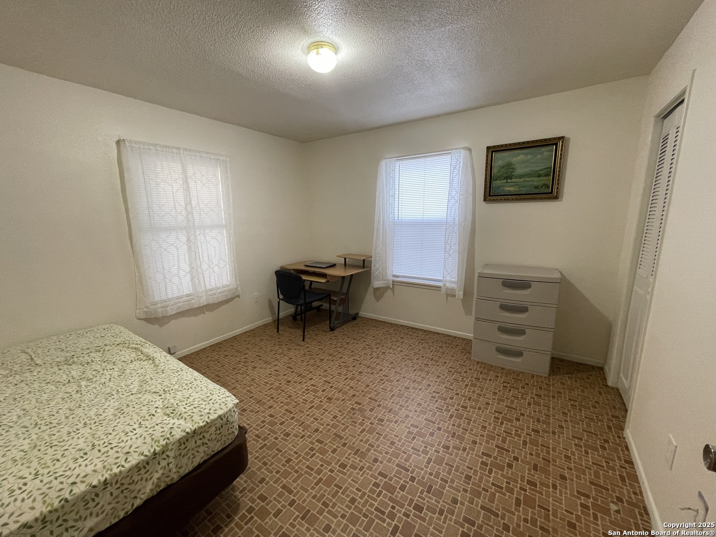 311 3rd Street Christine, TX 78012 - Photo 8 of 10 a bedroom with a bed and a dresser