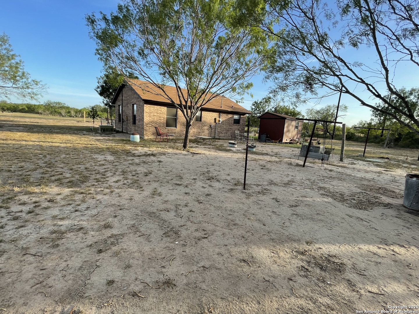 311 3rd Street Christine, TX 78012 - Photo 9 of 10 a view of a yard with wooden fence