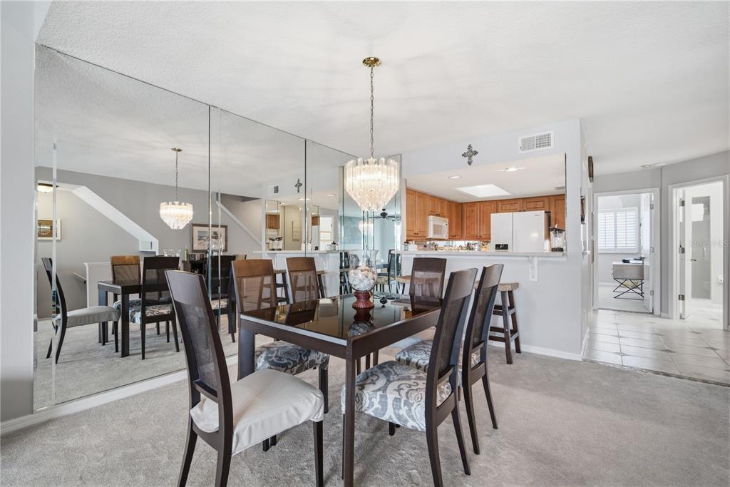 643 Garland Circle Indian Rocks Beach, FL 33785 - Photo 16 of 81 a dining room filled with furniture and a chandelier