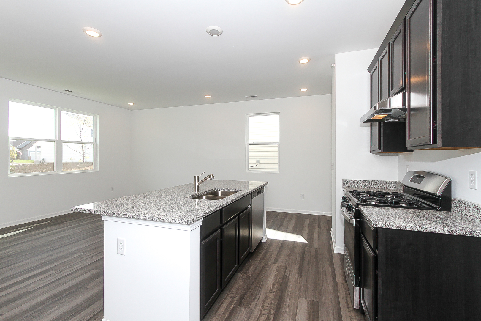 451 Comstock Road South Elgin, IL 60177 - Photo 11 of 30 a kitchen with granite countertop a sink a stove and wooden floor