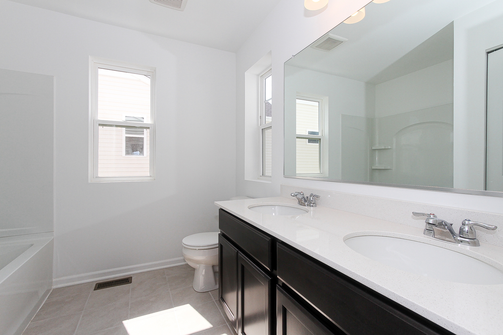 451 Comstock Road South Elgin, IL 60177 - Photo 22 of 30 a bathroom with a sink a toilet a mirror and a window