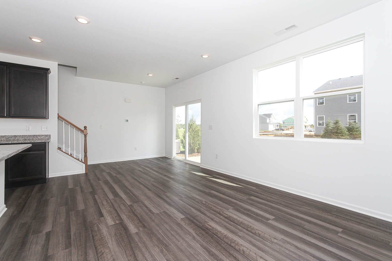 451 Comstock Road South Elgin, IL 60177 - Photo 3 of 30 a view of an empty room with wooden floor and a window