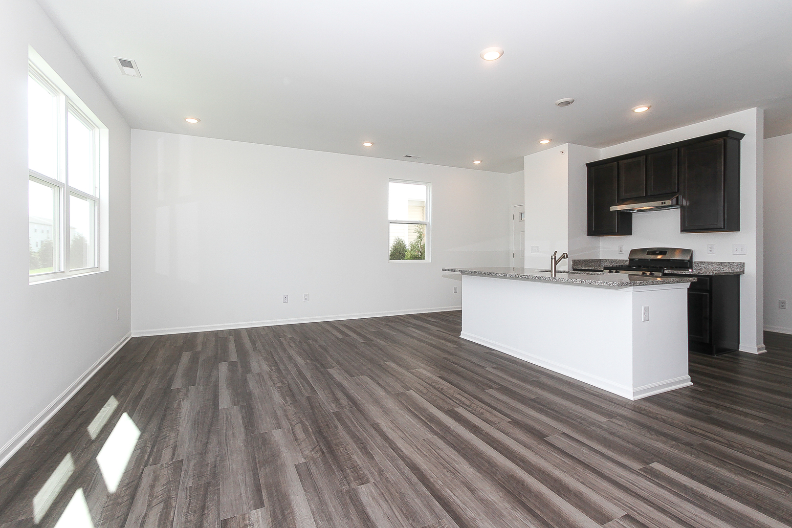 451 Comstock Road South Elgin, IL 60177 - Photo 4 of 30 a kitchen with stainless steel appliances a microwave a stove a sink dishwasher and a refrigerator with wooden floor