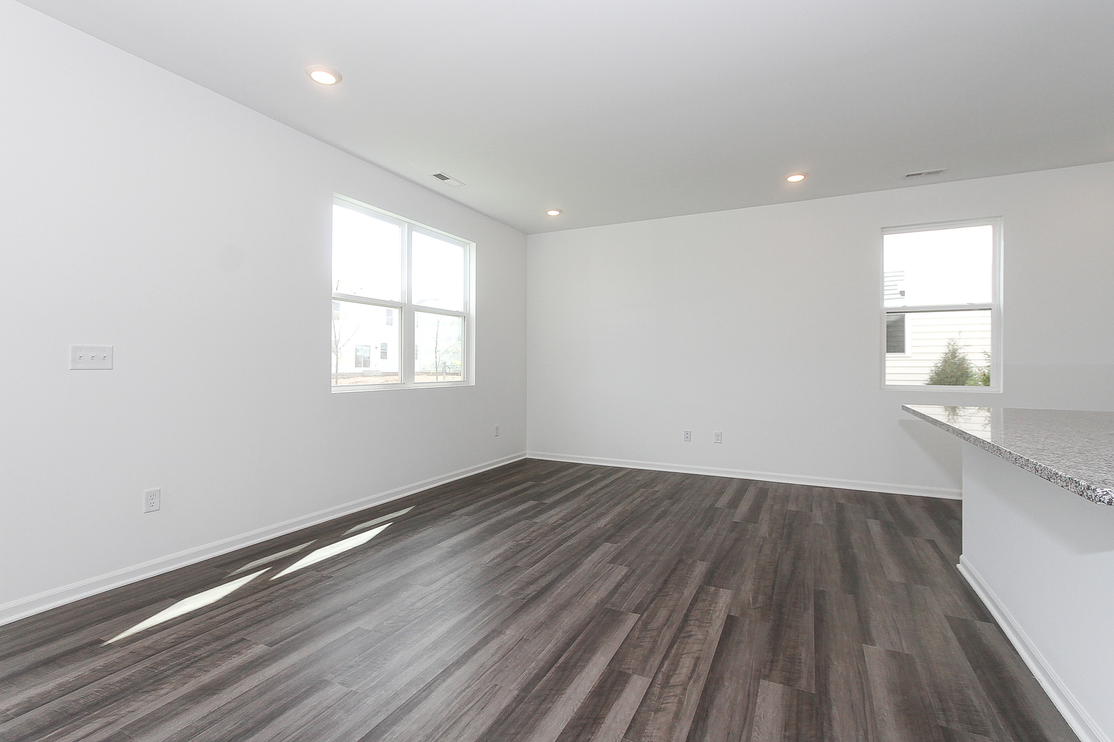 451 Comstock Road South Elgin, IL 60177 - Photo 5 of 30 an empty room with wooden floor and windows