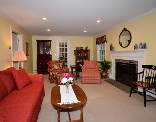4 Barringer Road Darien, CT 06820 - Photo 6 of 19 a living room with furniture a fireplace and a flat screen tv