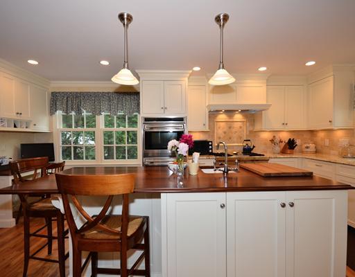 4 Barringer Road Darien, CT 06820 - Photo 8 of 19 a kitchen with a dining table chairs and white cabinets