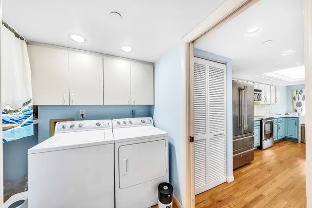 a view of a hallway with closet and chandelier