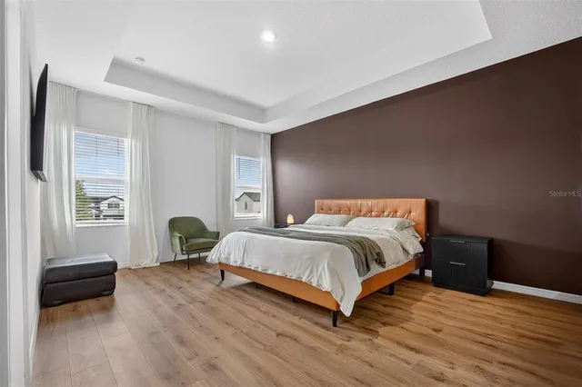 a bedroom with bed and a flat screen tv