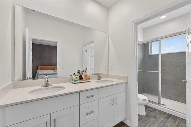 a white toilet next to a bathroom