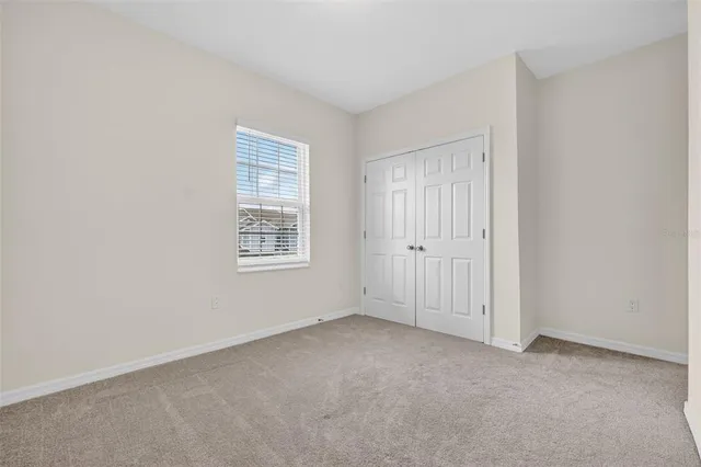 a bedroom with a bed and potted plant