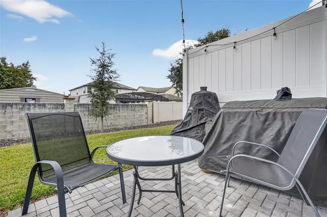 a swimming pool with outdoor seating and yard