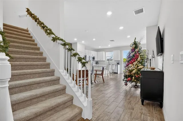a living room with furniture and kitchen view