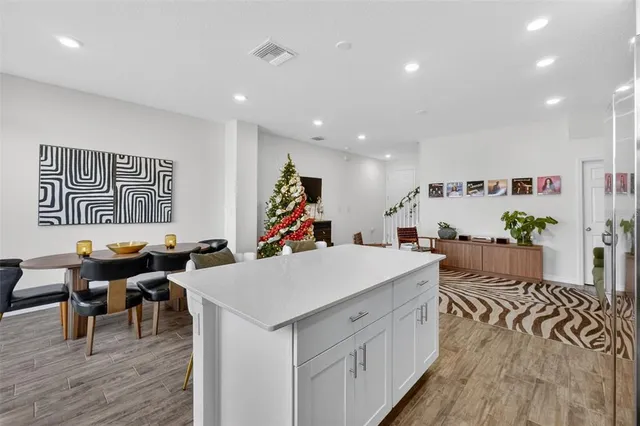 a large white kitchen with a large window
