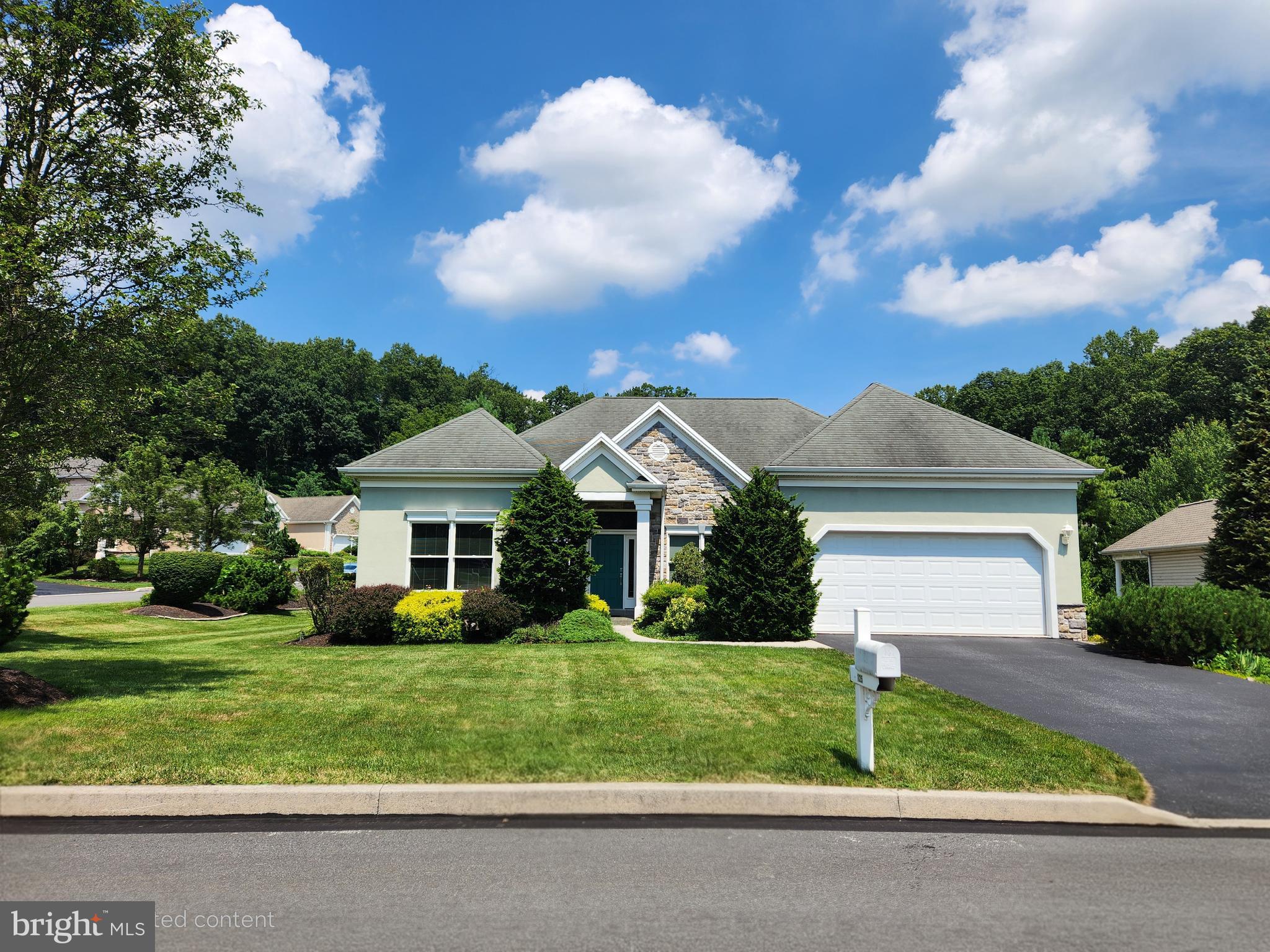 a front view of house with yard and green space