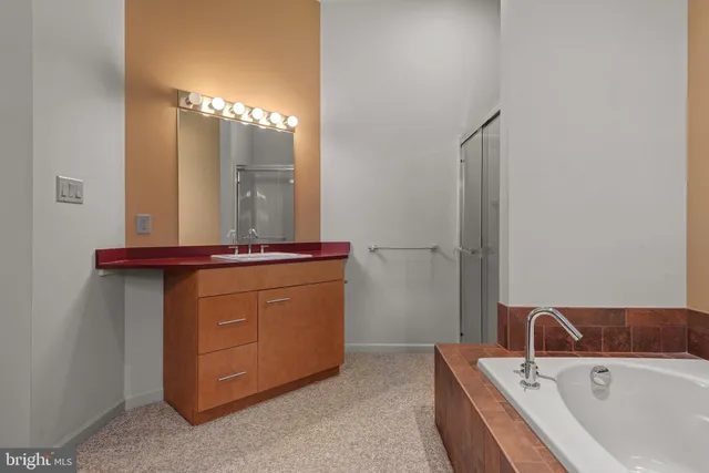 a spacious bedroom with a bed and a window