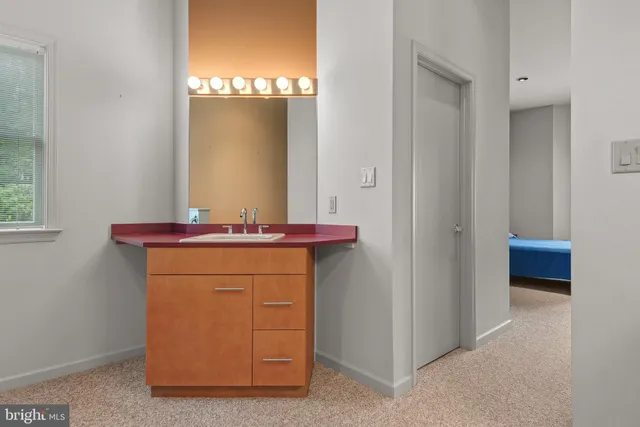 a bedroom with a bed and painting on the wall