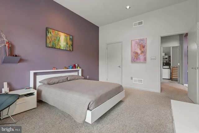 a room with furniture a window and a bookshelf