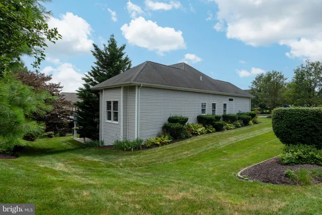 a balcony with wooden floor table and chairs