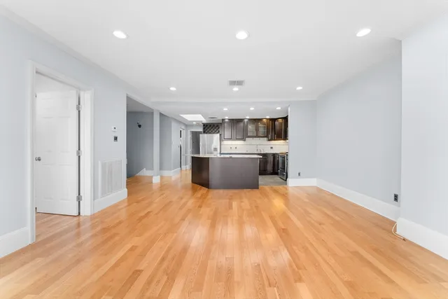 a view of kitchen with kitchen island sink and center island