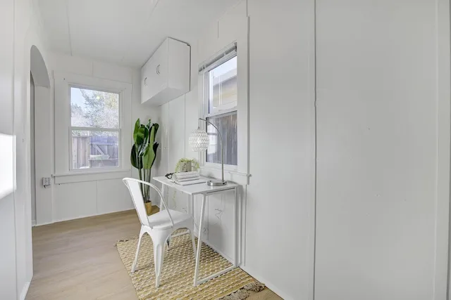 a bedroom with a bed and a table with chair