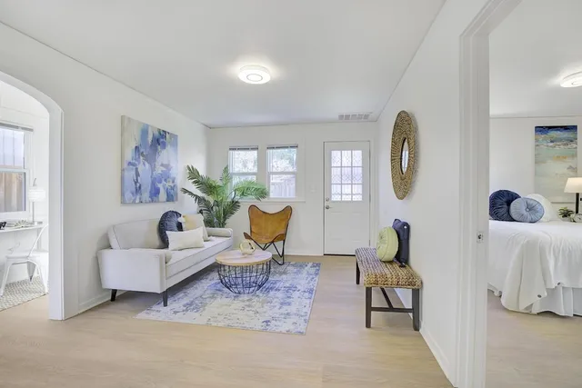 a view of a livingroom with furniture and a potted plant