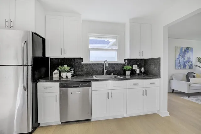 a kitchen with cabinets and window