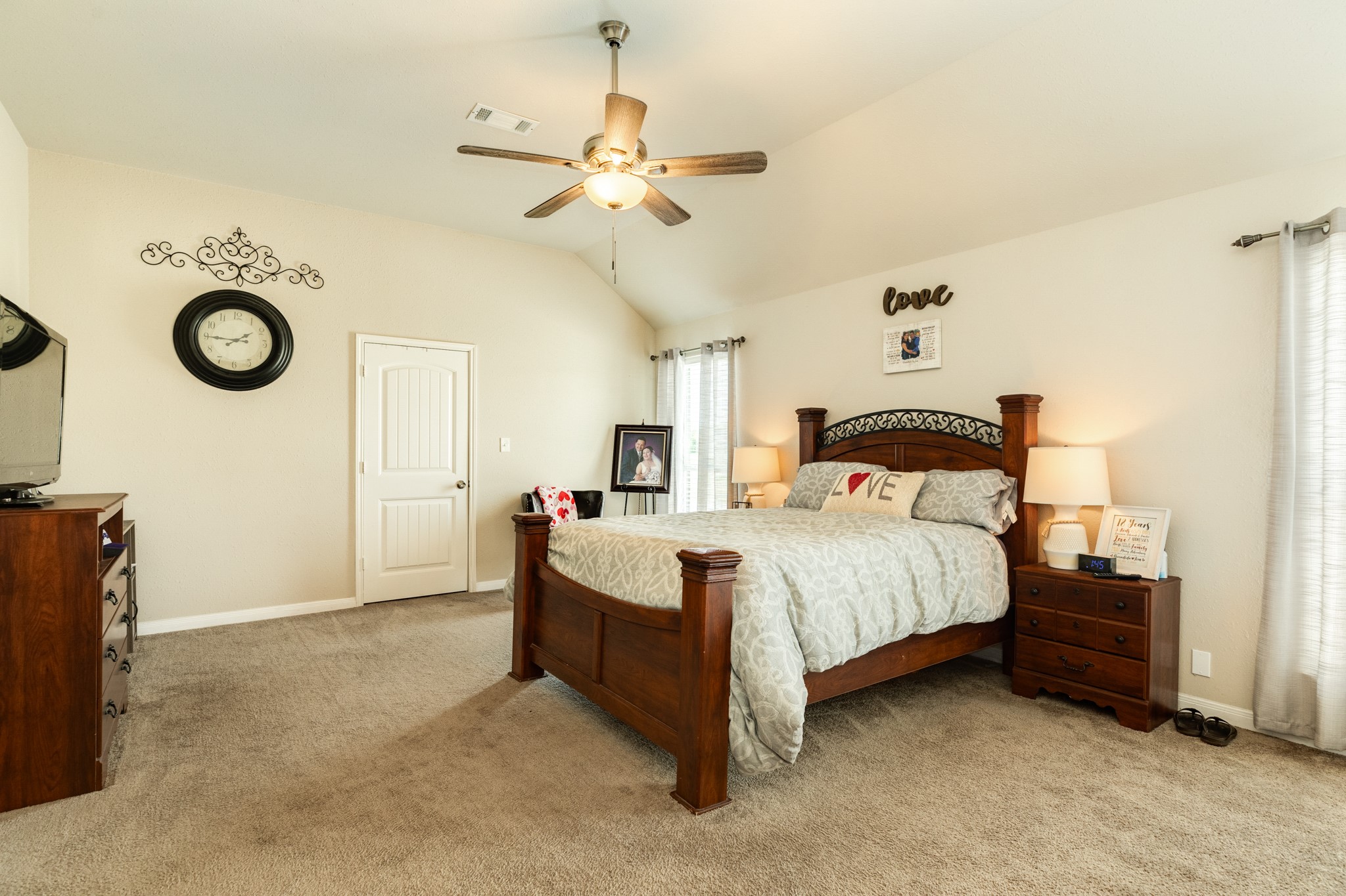 920 Quarter Horse Trail Angleton, TX 77515 - Photo 12 of 21 a bedroom with a bed and a chandelier