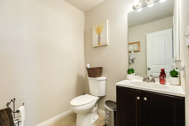 a bathroom with a sink a toilet and mirror