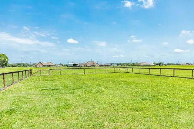 a view of a field of grass and trees