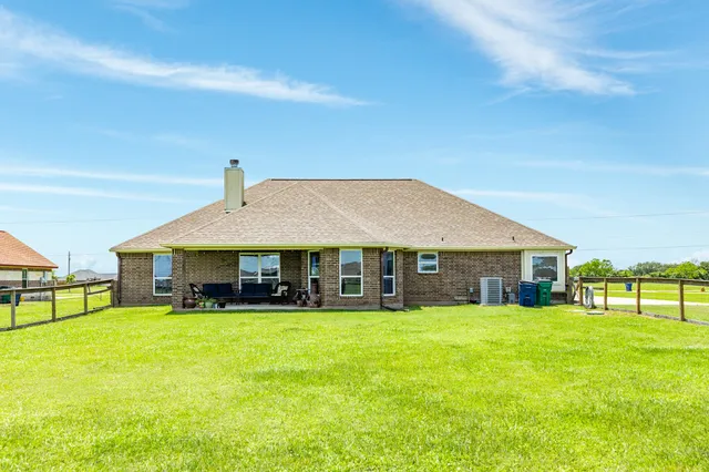 a view of a house with a yard and sitting area