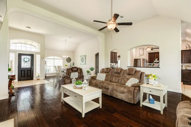 a living room with furniture and a wooden floor