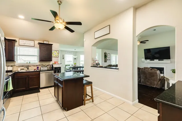 a kitchen with a sink appliances and cabinets