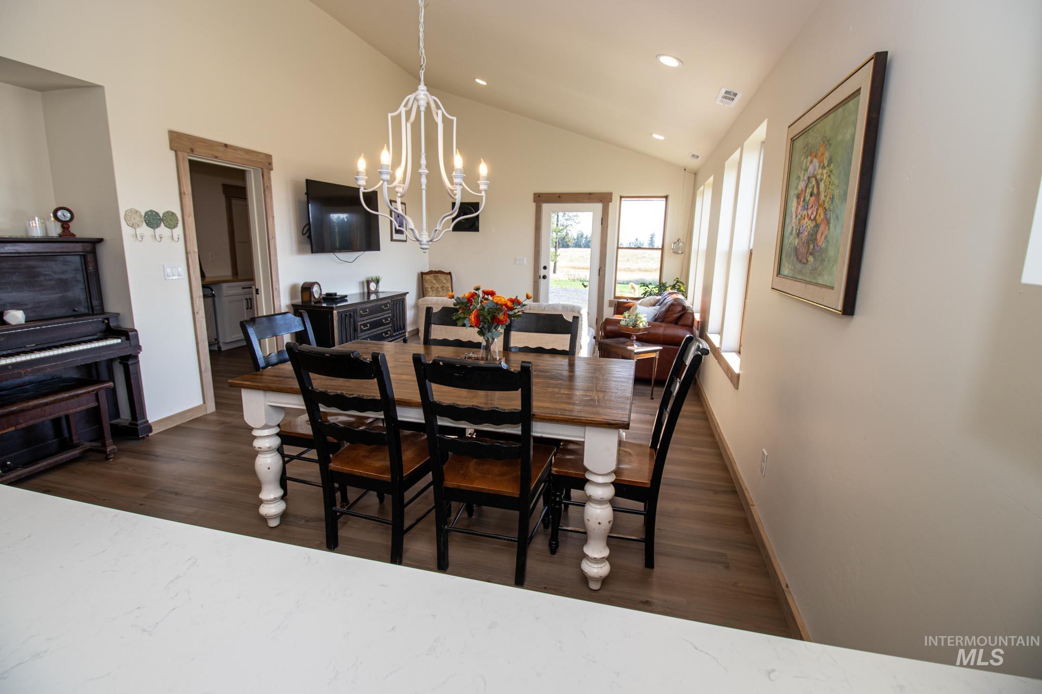 263 Glory Lane Orofino, ID 83544 - Photo 9 of 48 Dining space featuring dark wood-style floors, lofted ceiling, and suspended lighting