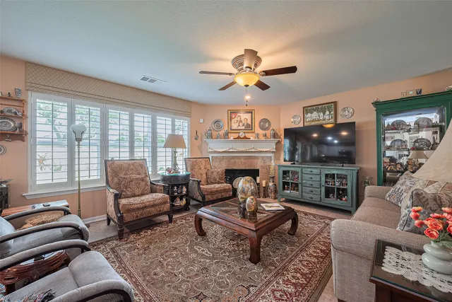 a living room with furniture a fireplace and a flat screen tv