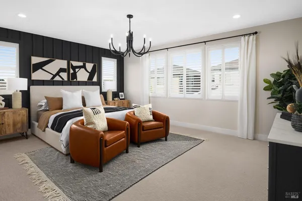 a bedroom with furniture and a large window